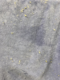 Towel in bathroom that was covered in fluff that fell off everywhere