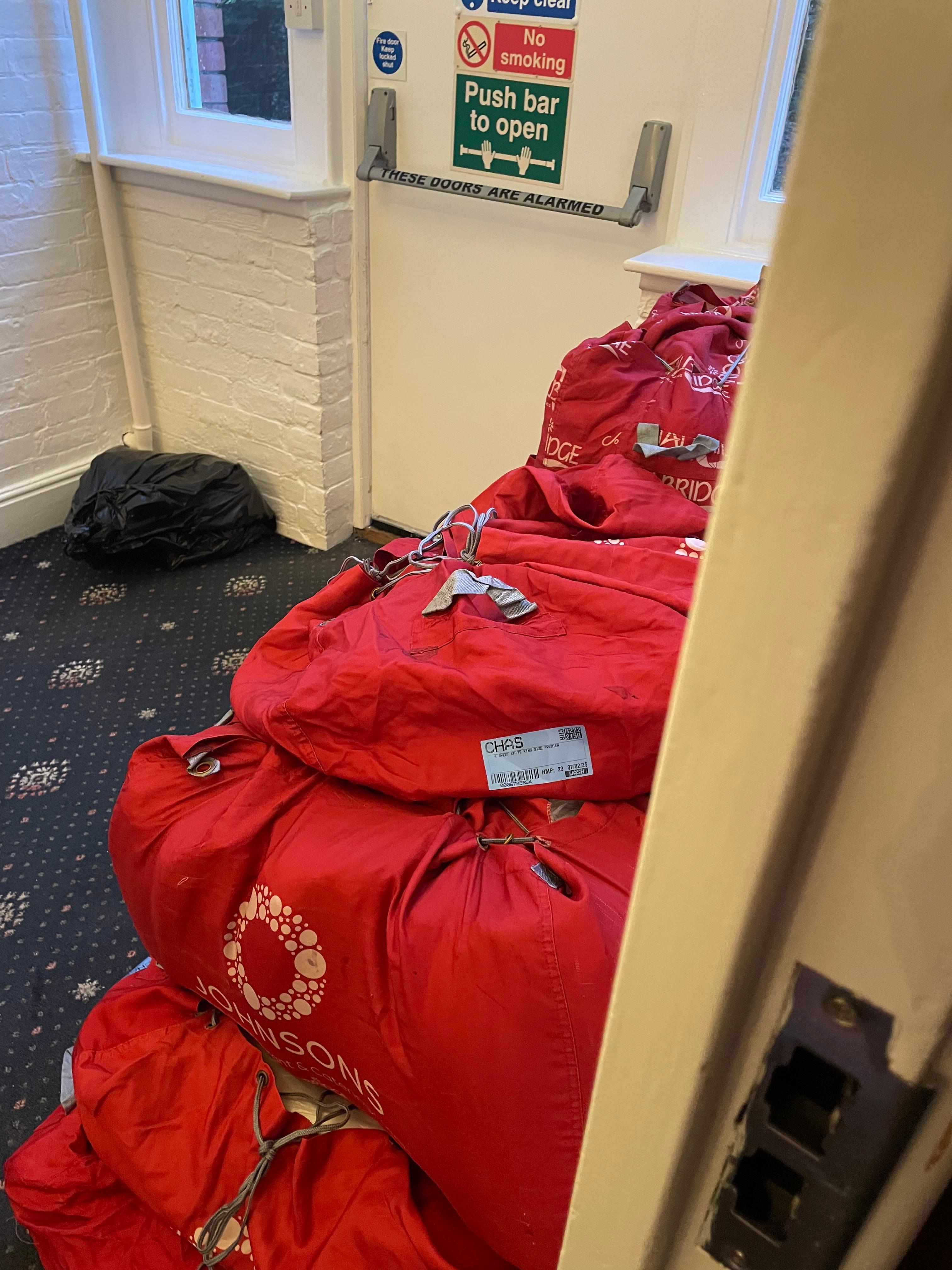 Laundry bags piled outside my room.