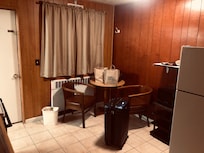 Cute enough kitchen table. (Love the wood paneling!)