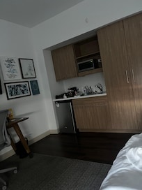 Nice kitchen with dishes and small refrigerator.