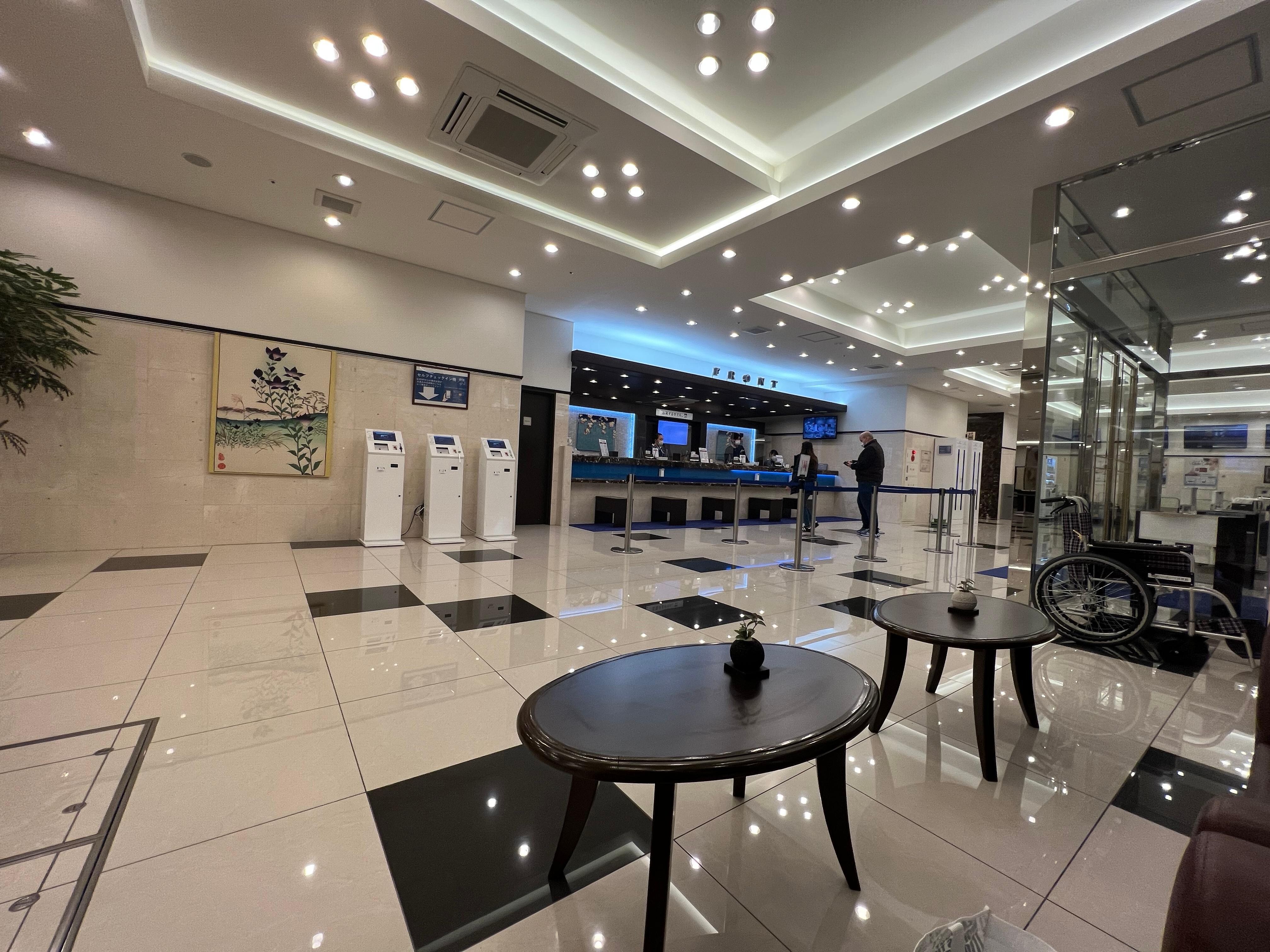 Reception area where you are greeted by sharply uniformed friendly concierges and guest relations personnel