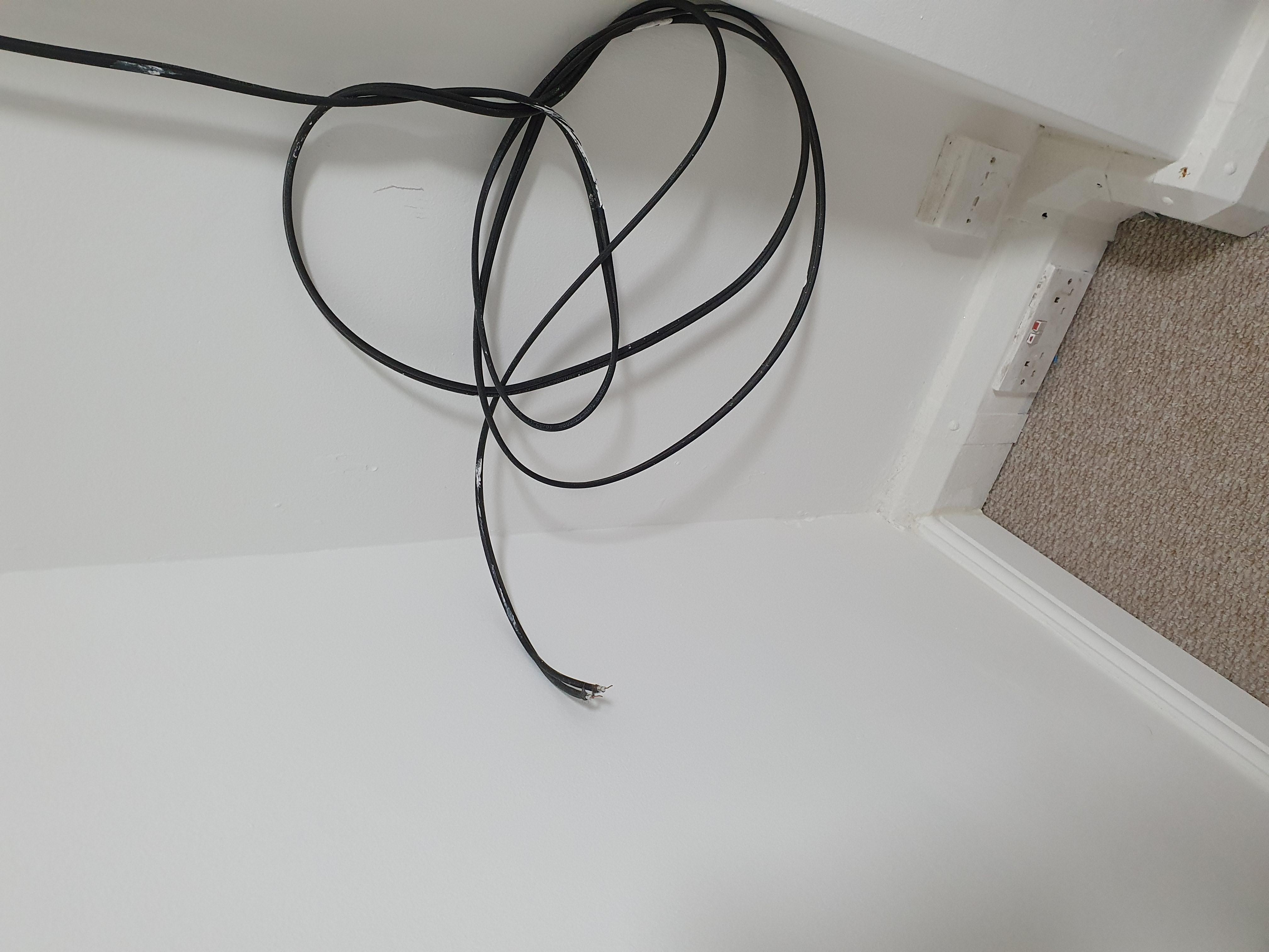 Exposed wires at the foot of the bed