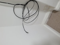 Exposed wires at the foot of the bed