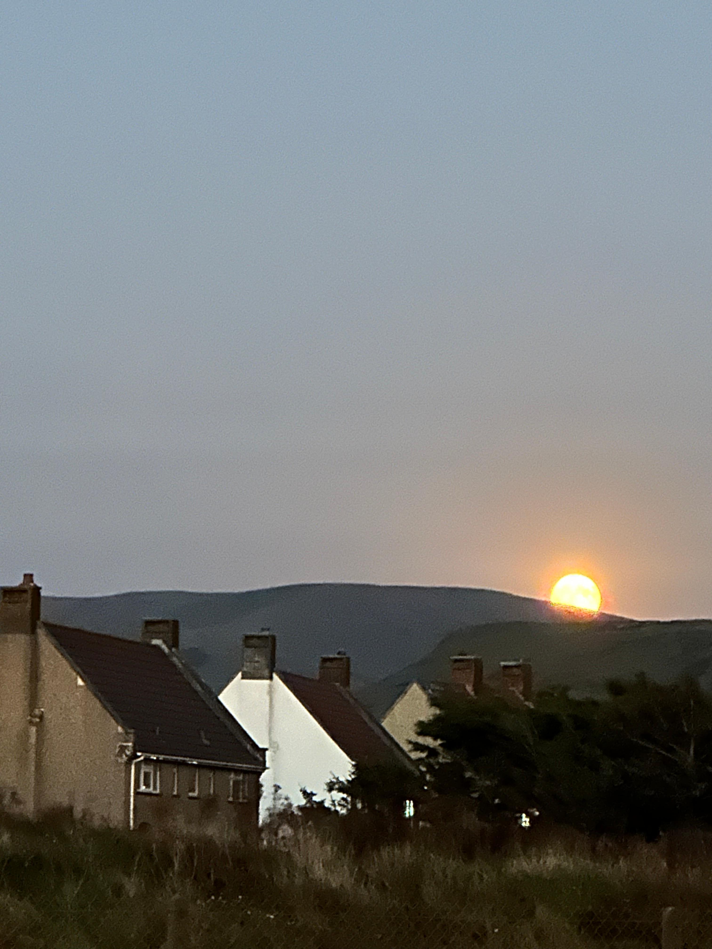 Full moon rising at the end of walkway 