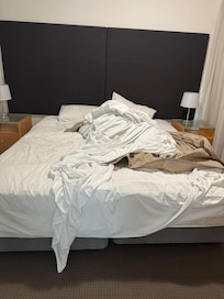Unmade bed on arrival