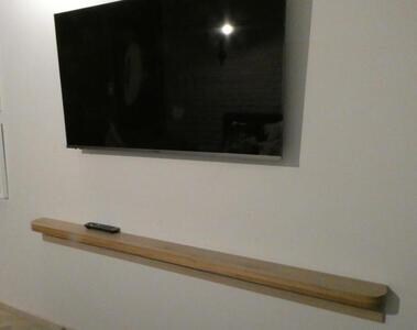 The shelf for the remote control. Long, but not deep enough to be useful for anything except the remote.