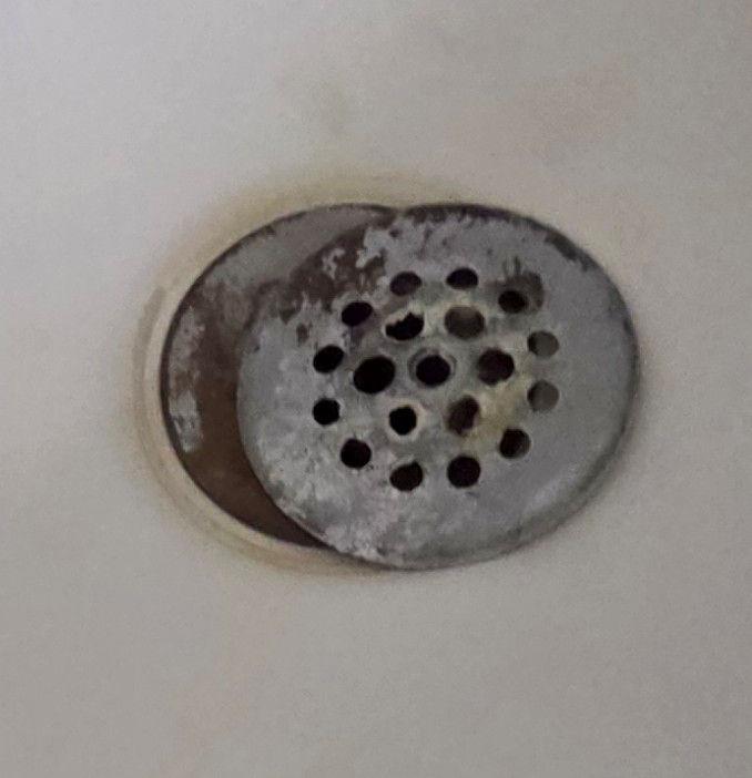 Bathtub drain cover corroded and dislodged