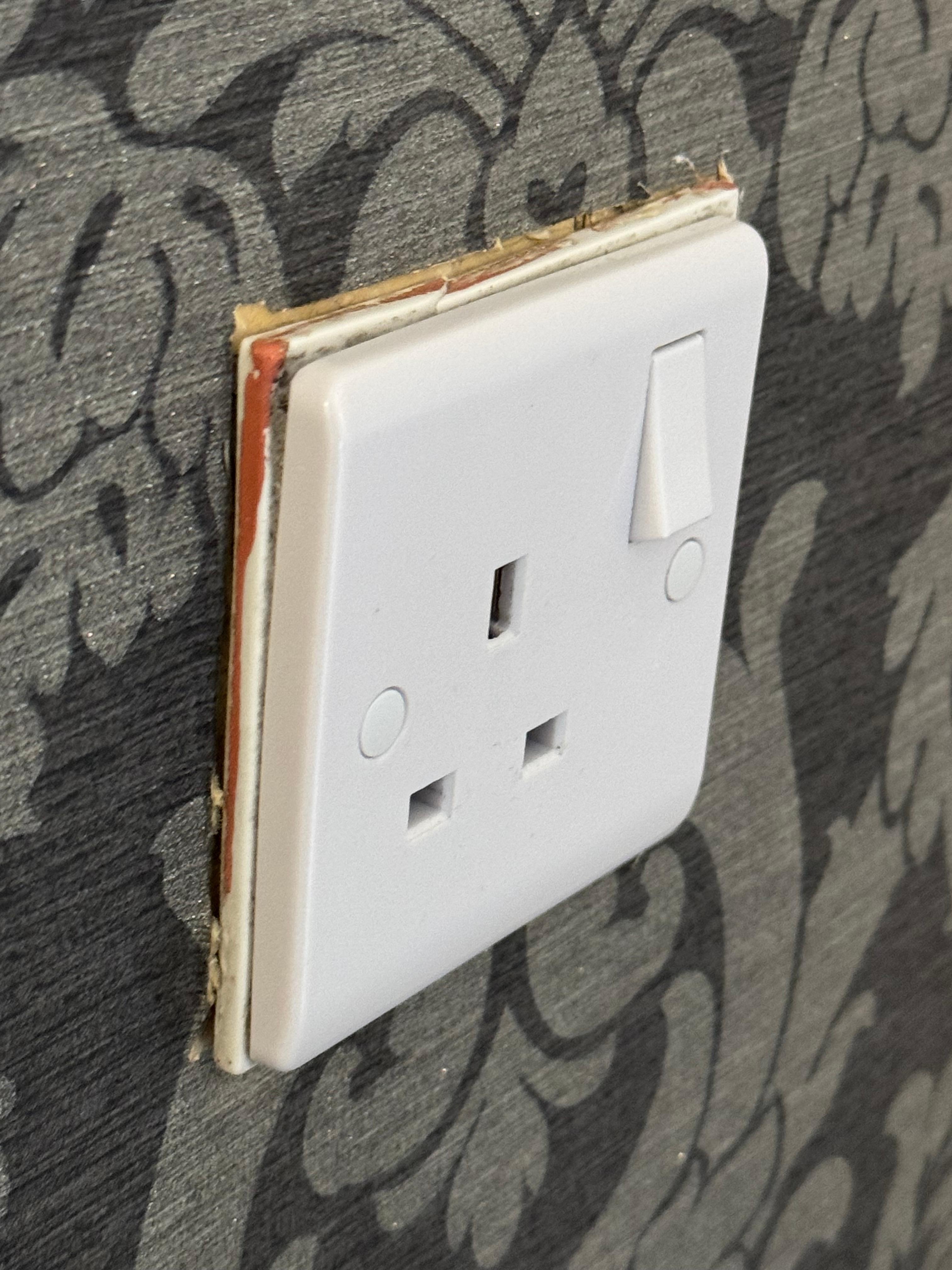 Electrical socket next to bed, exposed and moves when removing a plug.