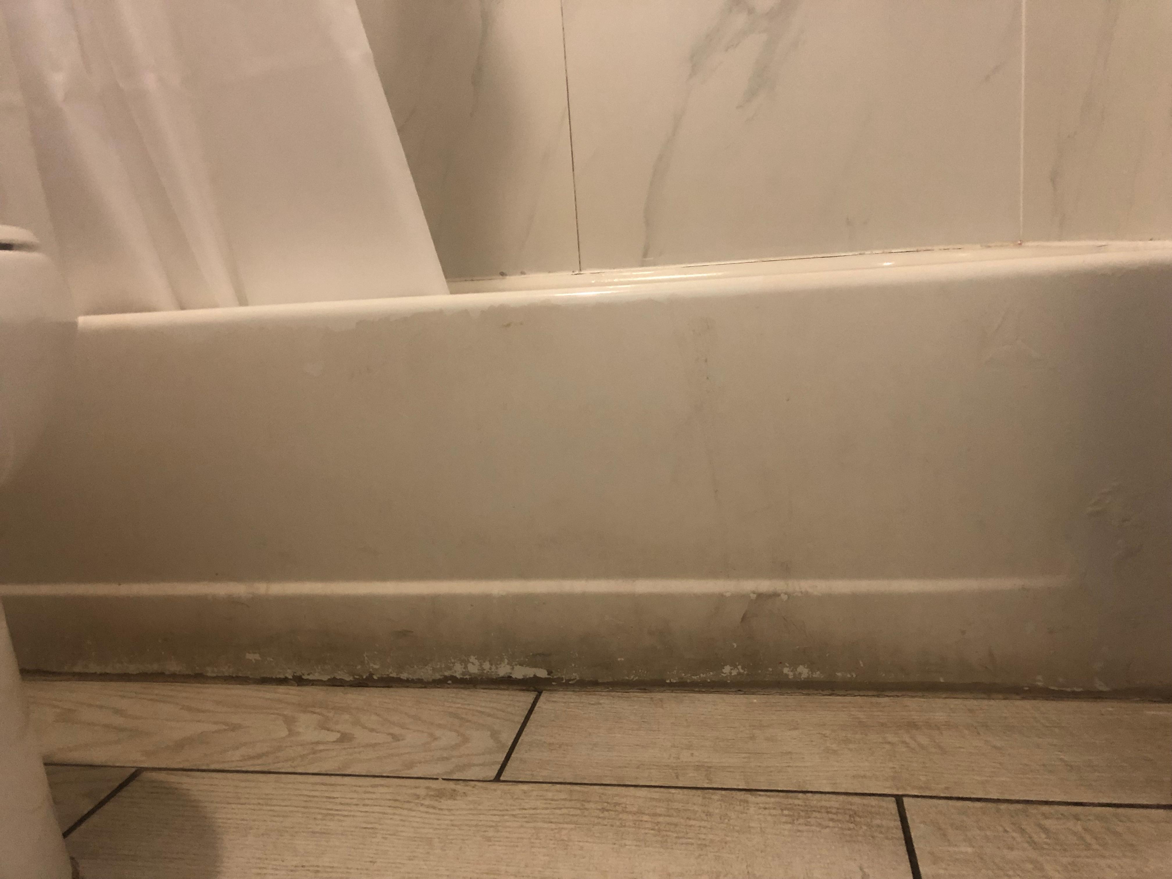 black mold & grime around outside of bathtub