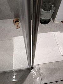 Water all over bathroom floor; open gap in shower frame