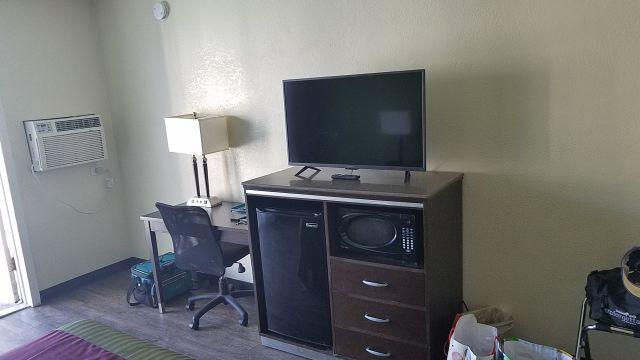 Living space, tv, fridge,microwave, desk.