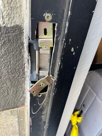 Outside door crowbarred open. Anyone can enter building anytime.