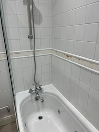 Painted tiles, with the paint scraped off revealing old tiles underneath