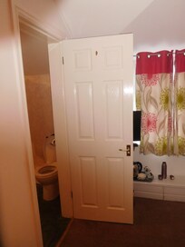 Bathroom door opening out into bedroom