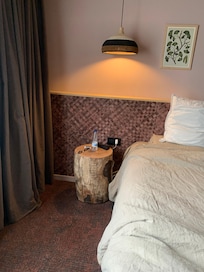 Bedside cabinet but large overhanging light.