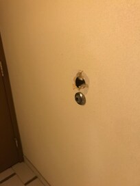 Hole in the wall behind the door