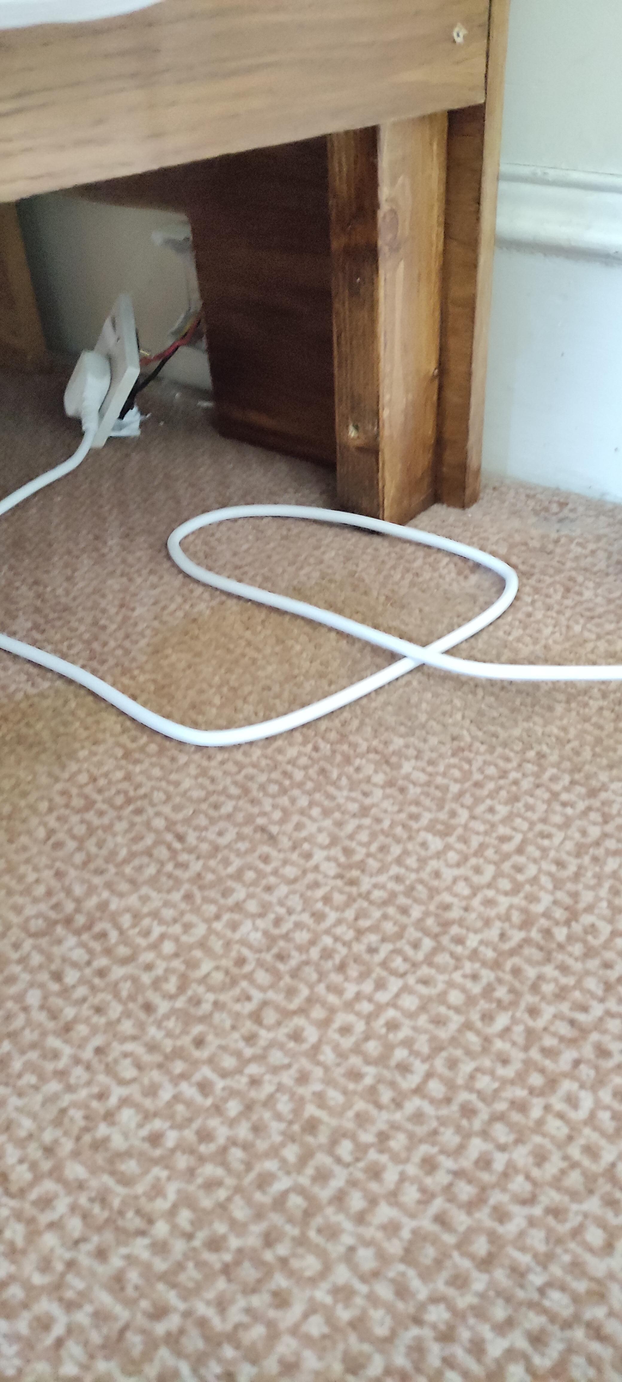 Broken socket, exposed wires and stained carpet