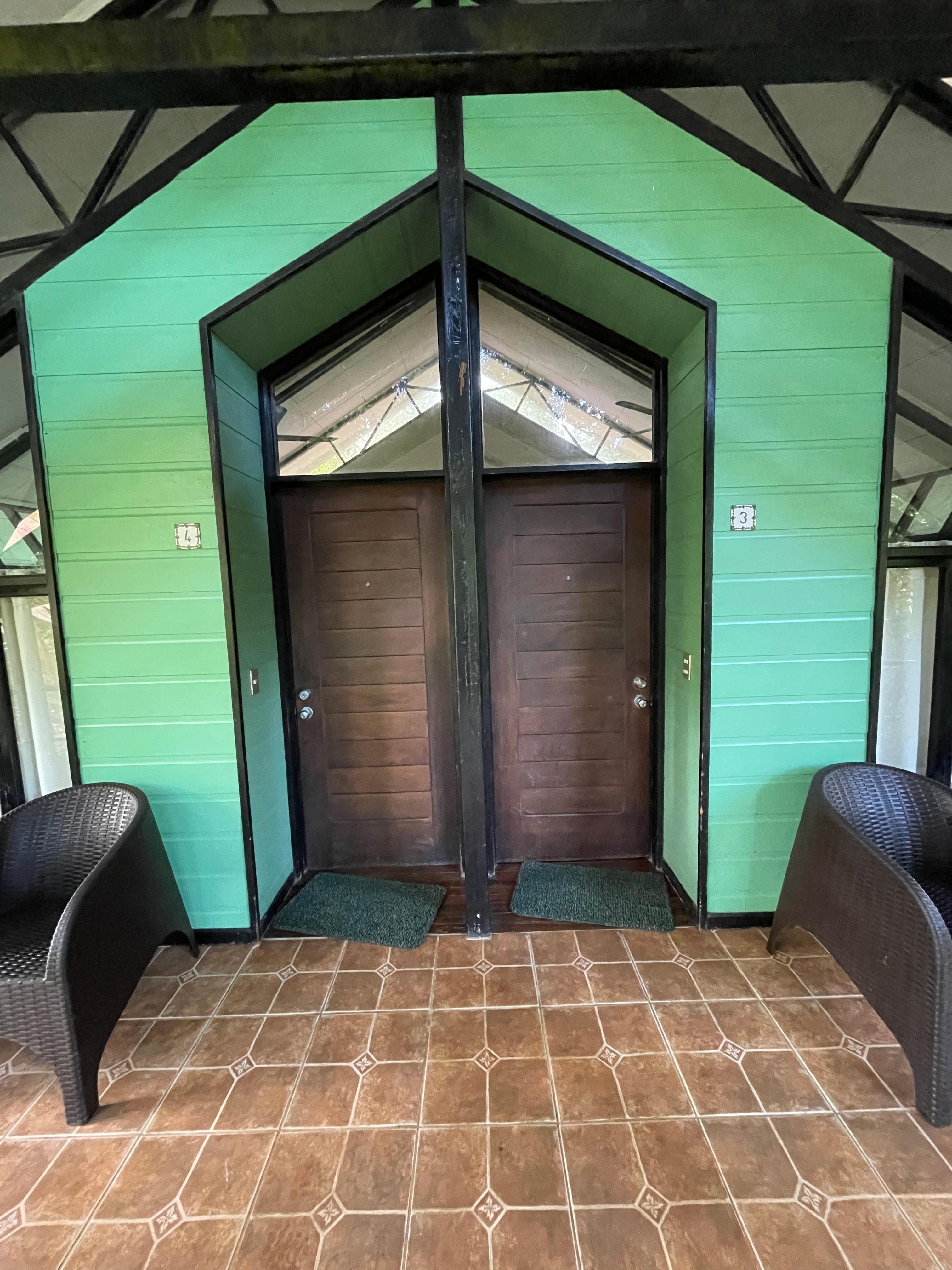 Two rooms adjoined with a shared porch. 