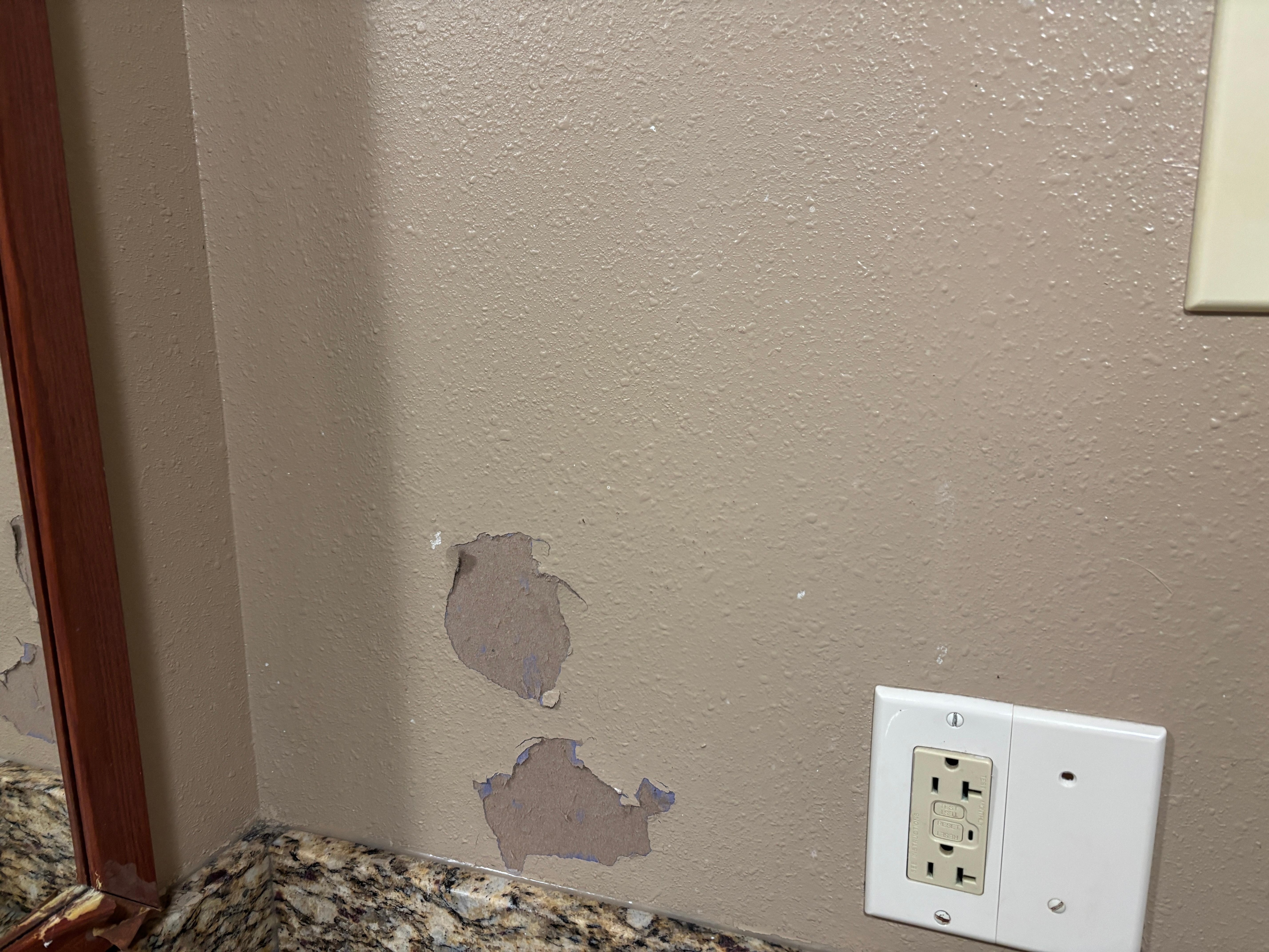 Chunks of paint missing, terrible light in the bathroom