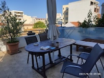 Sunny and spacious terrace with many well looked after plants.