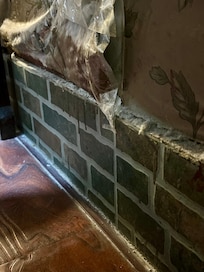 Dust along the room edges, taped up wallpaper