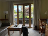 View of sitting area of room. Doors had option to open or tip in to vent.