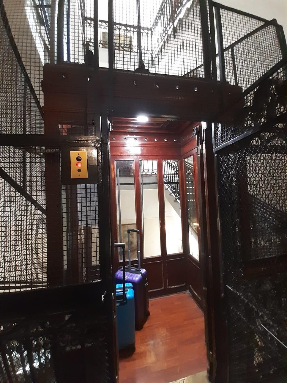 Elevador em que você fecha as portas com grades, de madeira bem frágil