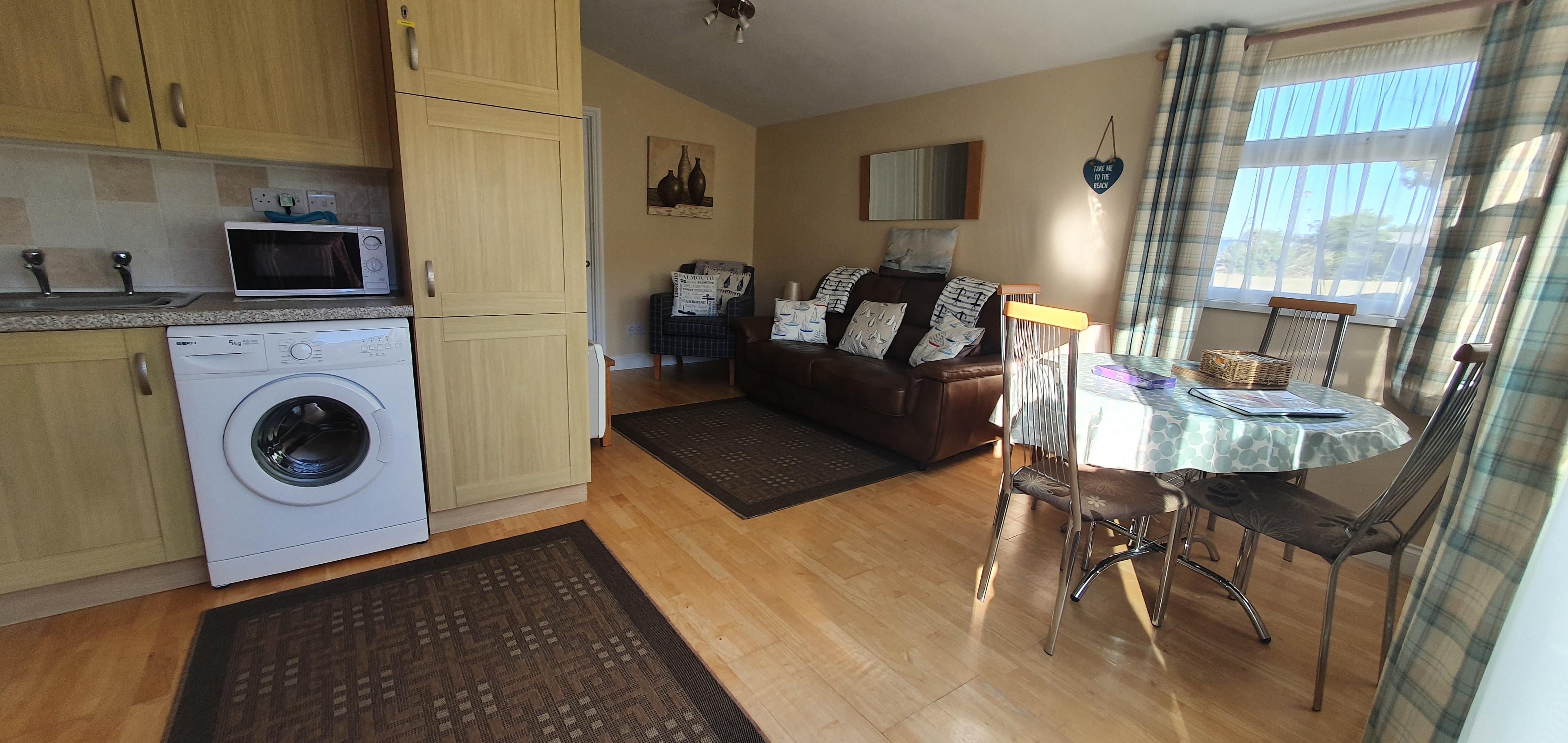 Living room, kitchen, dining area.