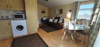 Living room, kitchen, dining area.