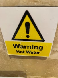 Hot water warning for the sink. The shower needed a serious health warning (as in 'Do Not Use') as it only offered scalding hot water,