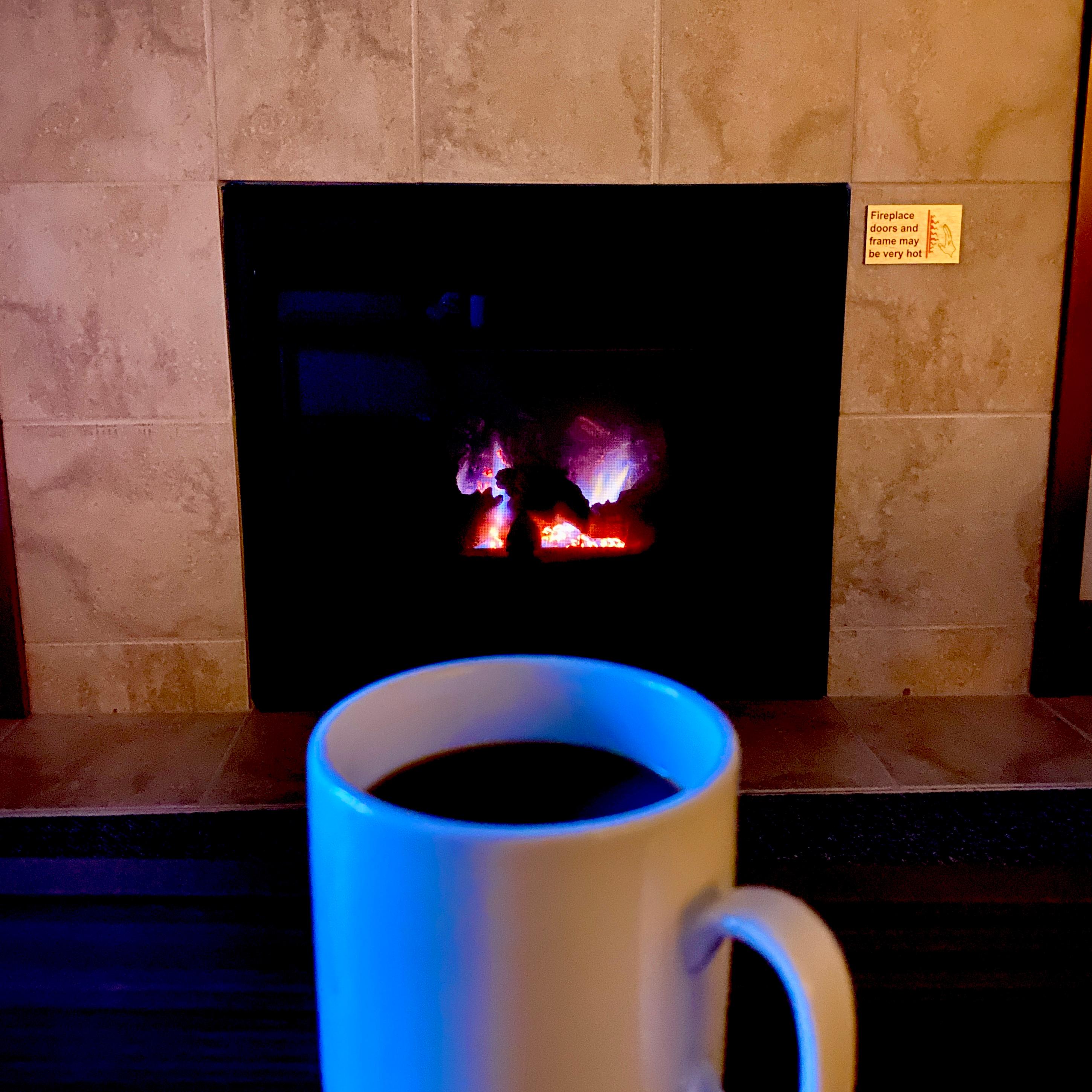 Enjoying a cup of tea (which was provided in the room) by the fireplace in our room