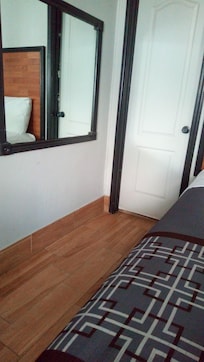 Toward bathroom with queen size bed