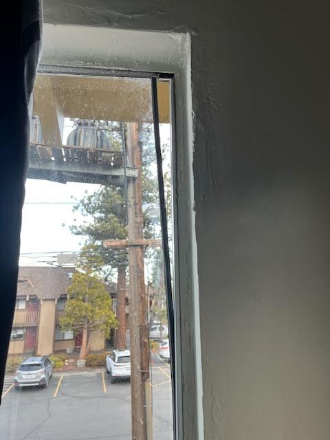 Damaged window, single pain glass separating from frame