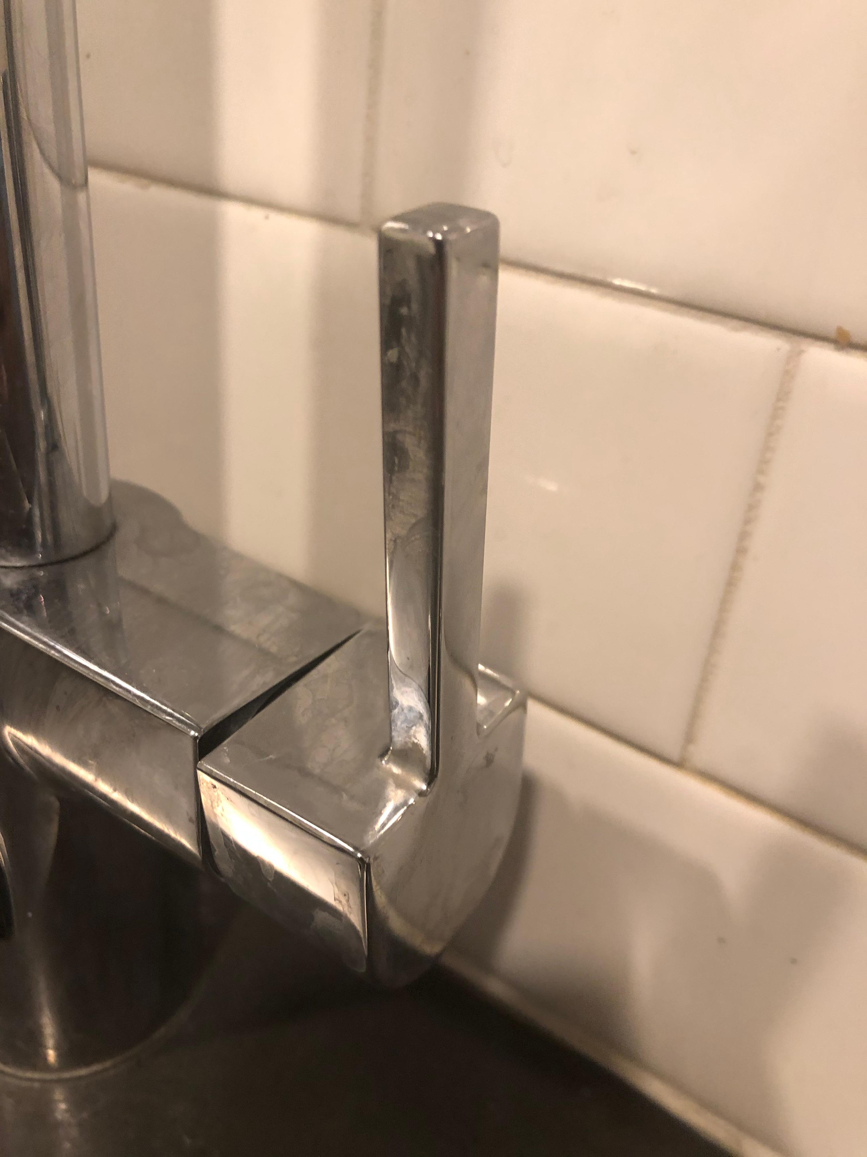 Kitchen sink faucet with sticky grime.