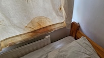 Unusual stain on the curtains, looks like a man has wiped himself down after night time activities