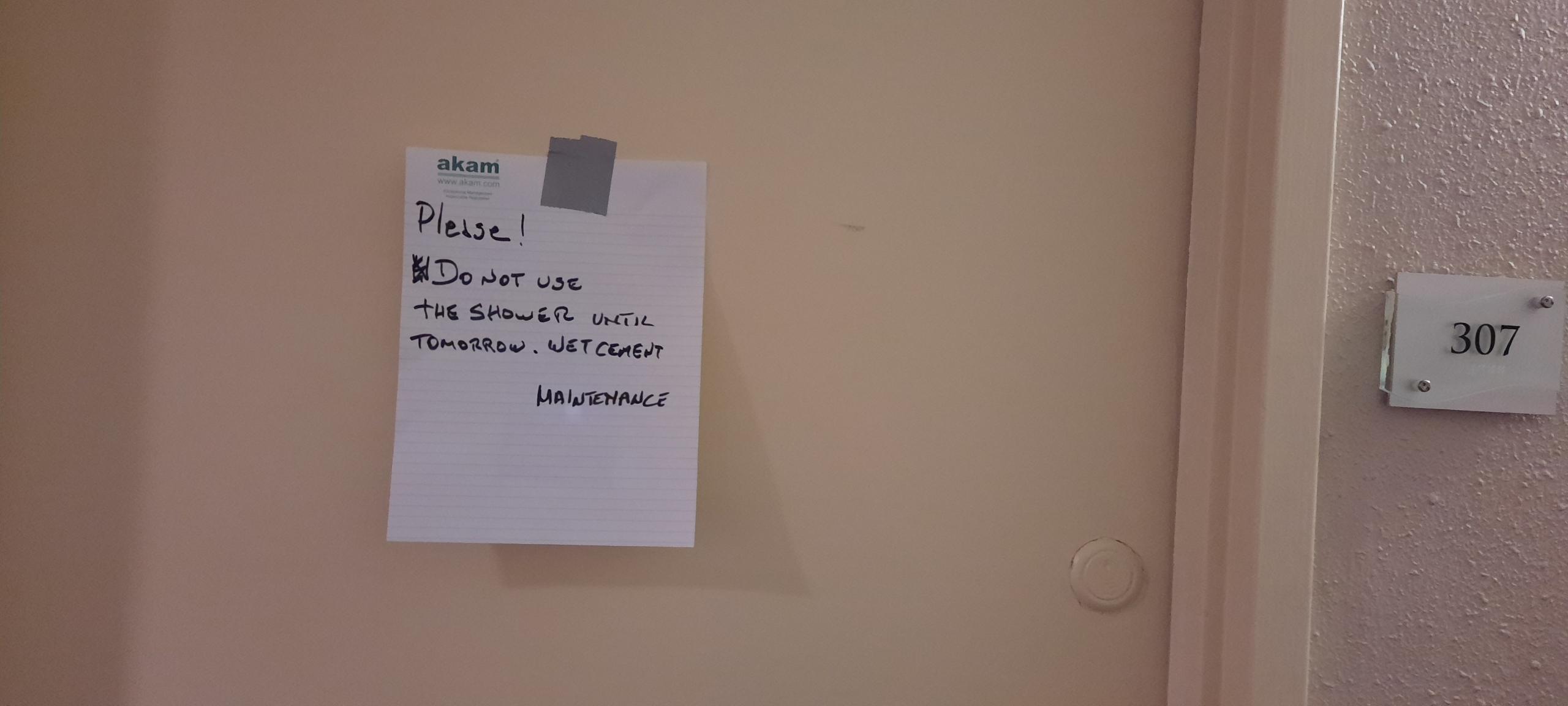 Maintenance note posted to door of the unit