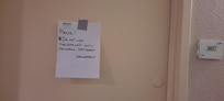Maintenance note posted to door of the unit