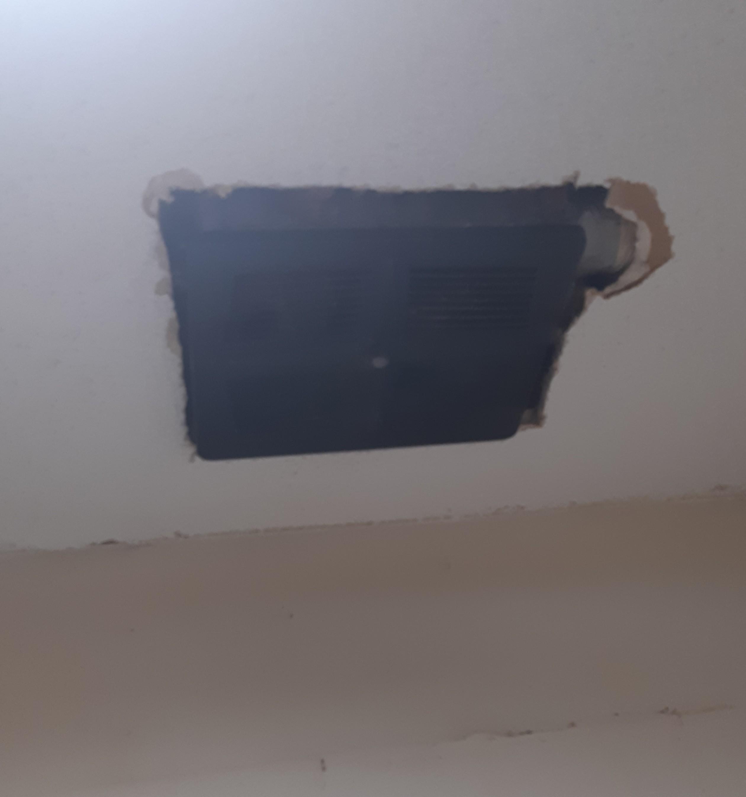 Hole in ceiling for loud extractor fan.