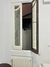Fake window in the room with the “view” of the pipes, dust, and garbage