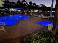 Night view of the pool and heated spa.