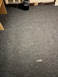 Carpet was uneven and worn/torn.