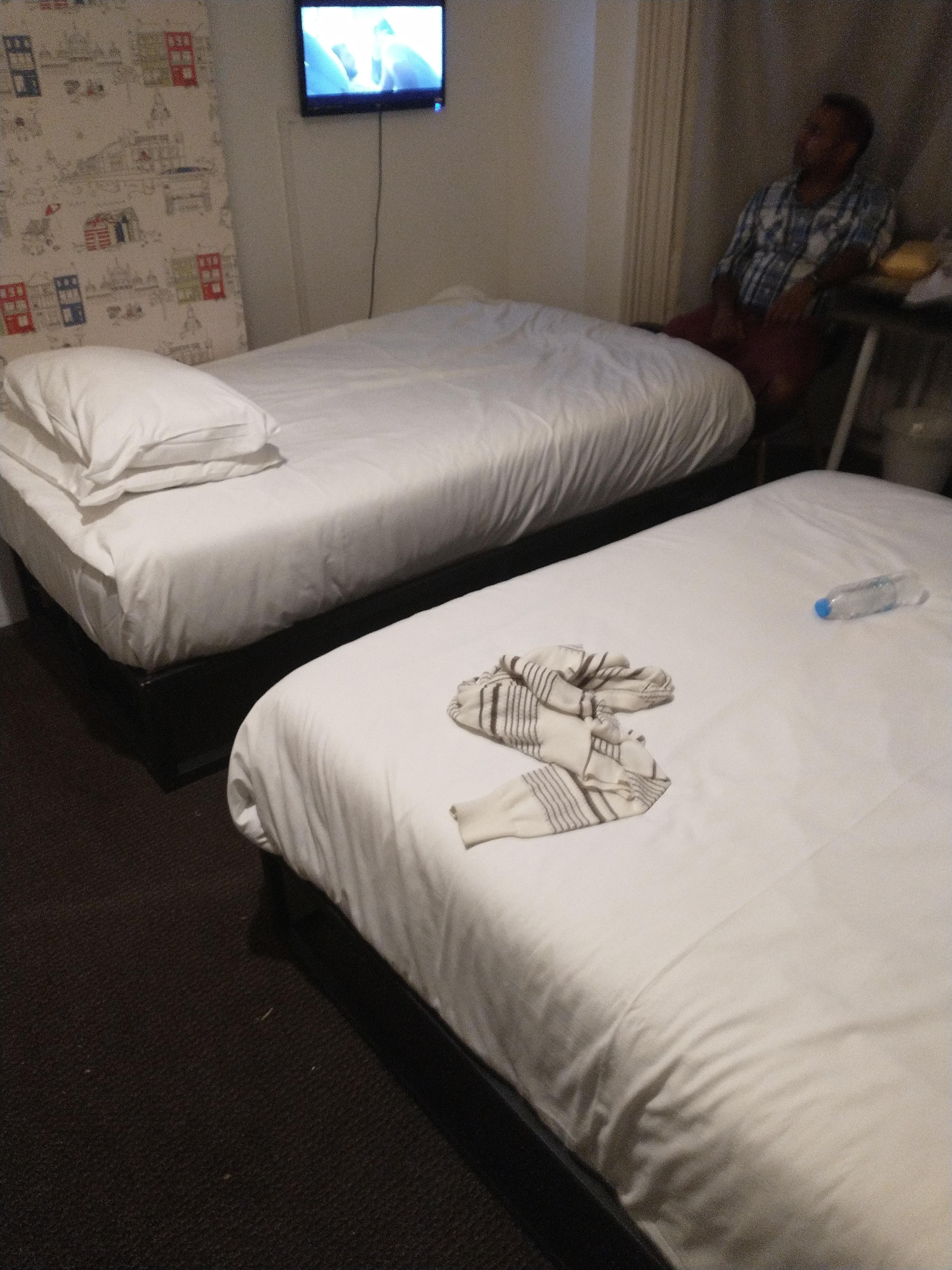 Two beds crammed together and gloried camp beds