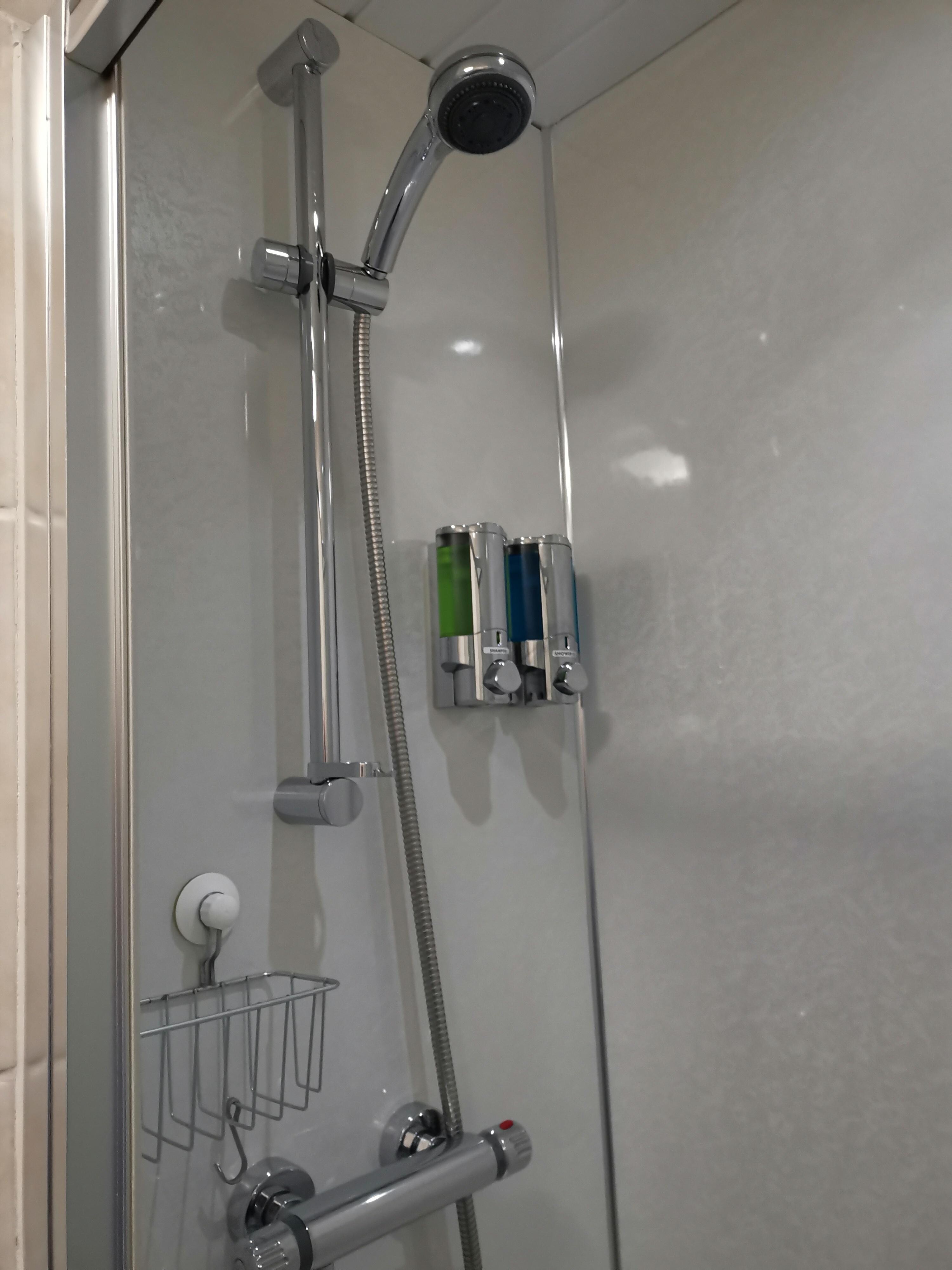 The shower has a light in it. 