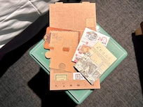 Room card with postcard, souvenir order form, room key.