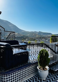 A large patio overlooks the city from Room 5