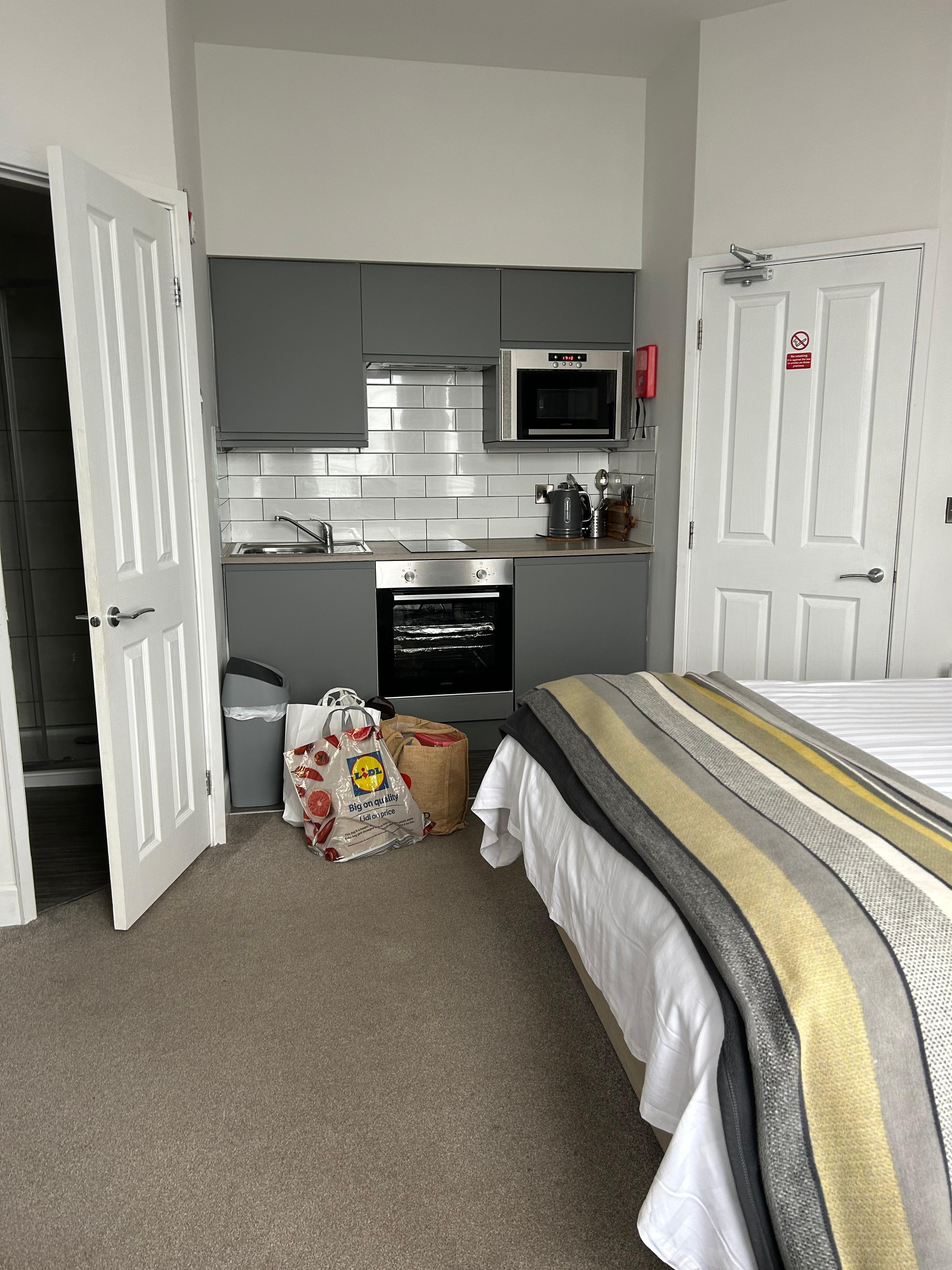 Kitchen with door leading to shower room