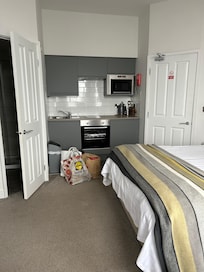 Kitchen with door leading to shower room