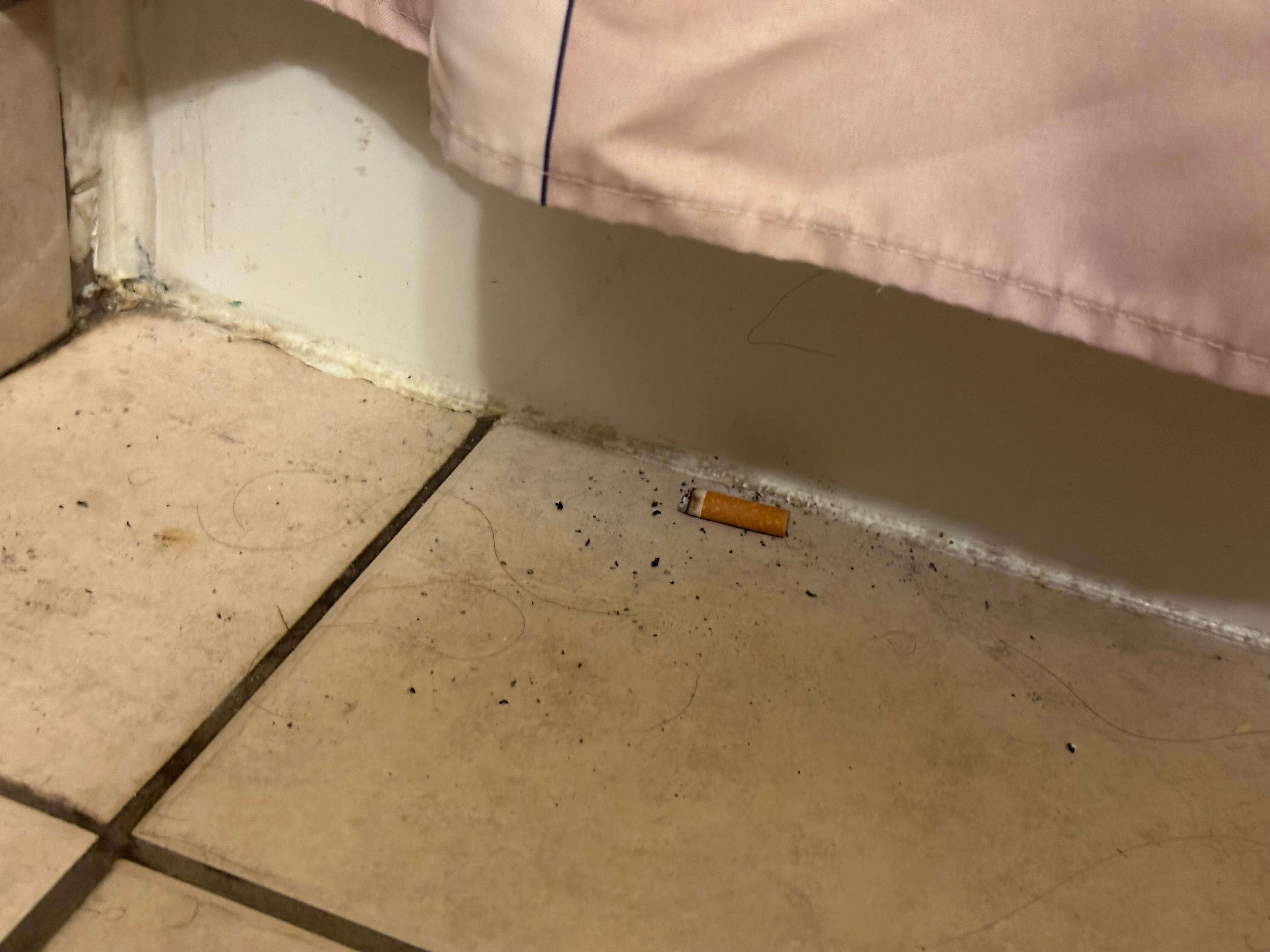 Cigarette butt in bathroom of non smoking room