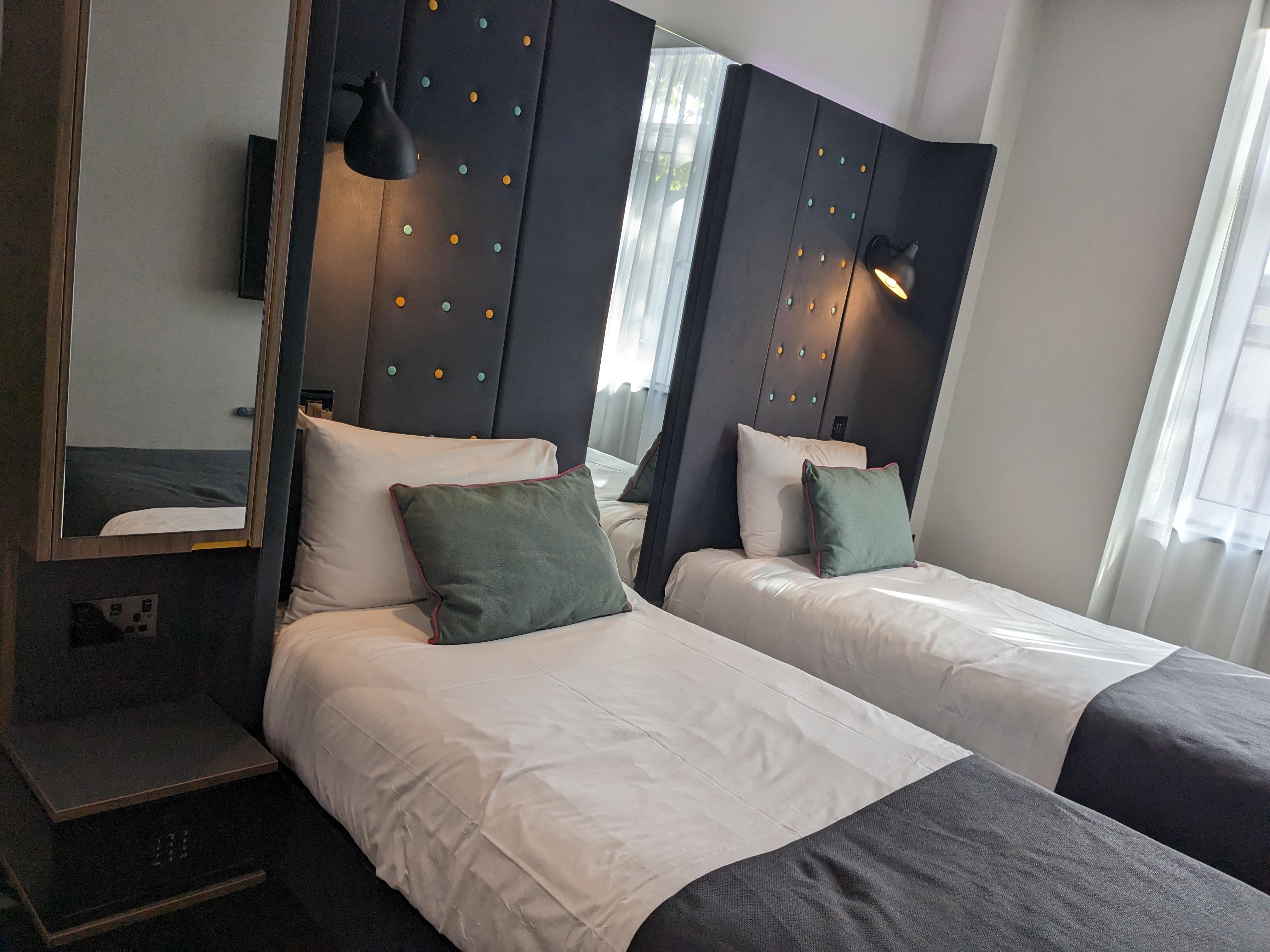 there's a small cabinet on the left side of the one bed