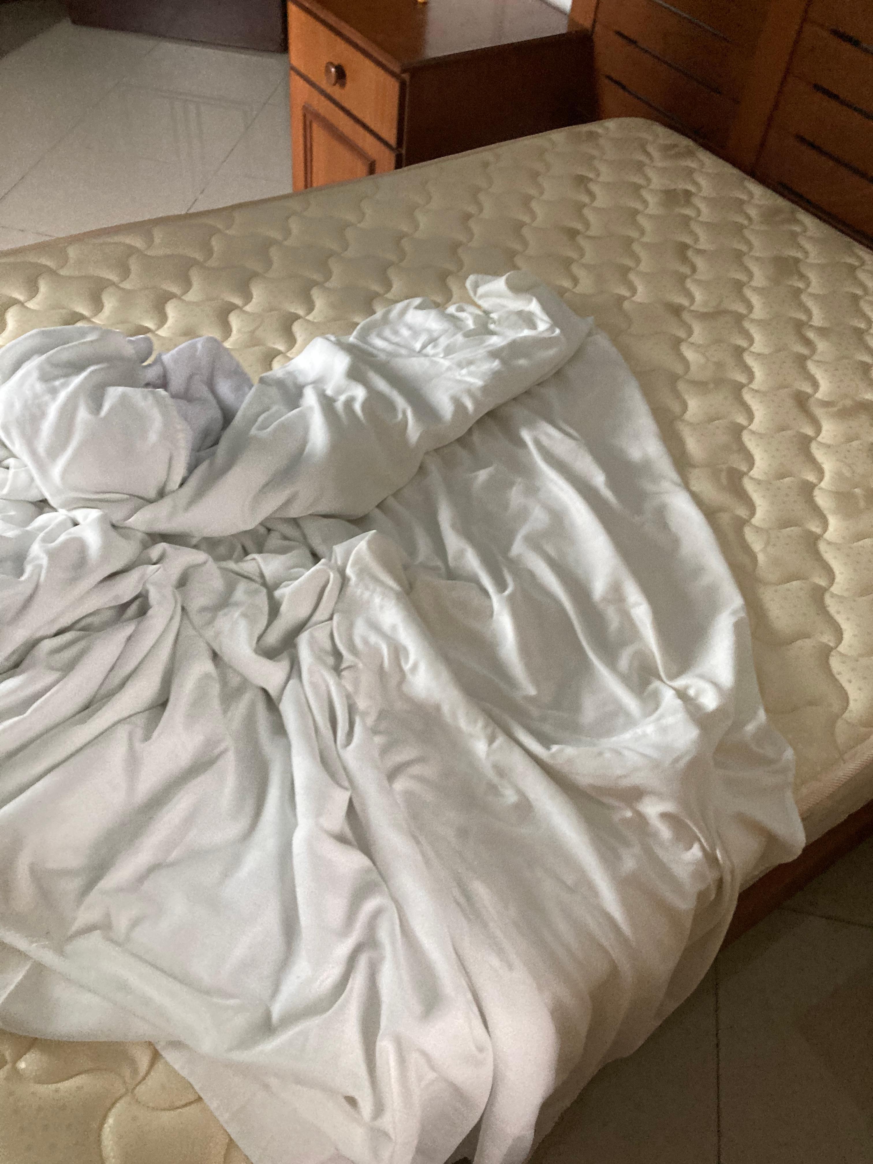 Only one bed sheet on top of mattress. Nothing to cover